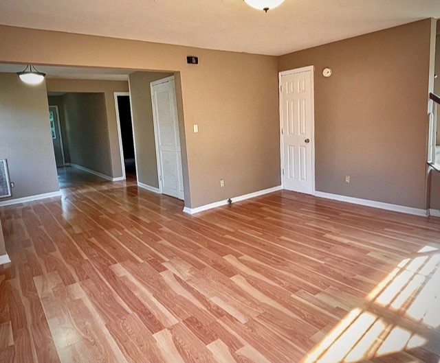 a view of a livingroom with wooden floor and closet