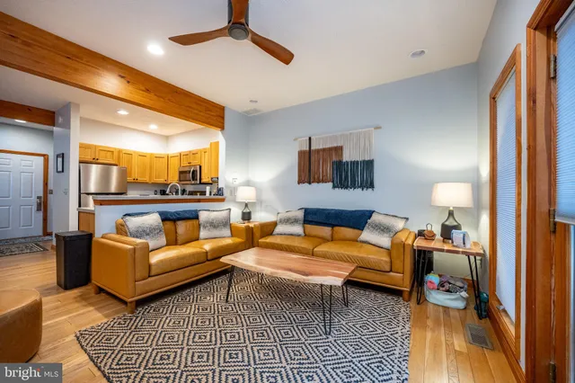 a living room with furniture a rug and a chandelier