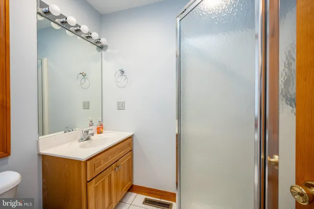a bathroom with a sink mirror vanity and toilet