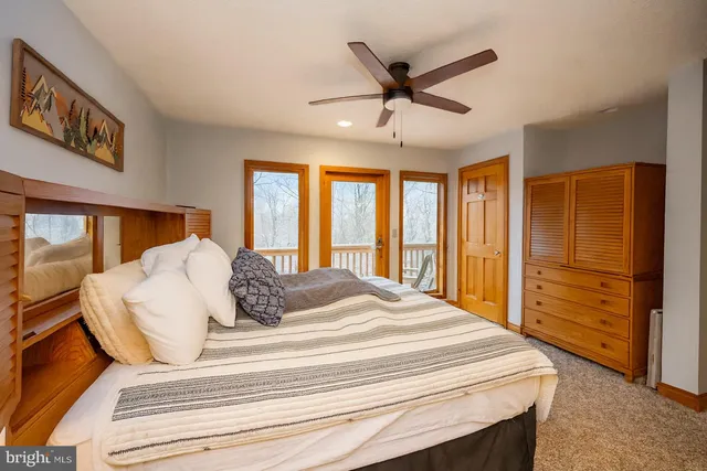 a bedroom with a large bed and a large window