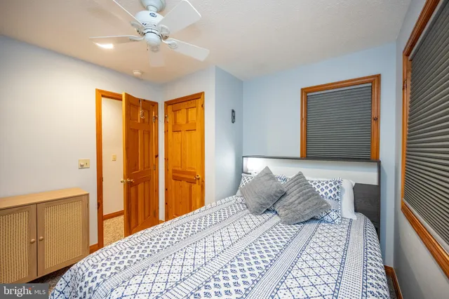 a bedroom with a large bed and a chandelier