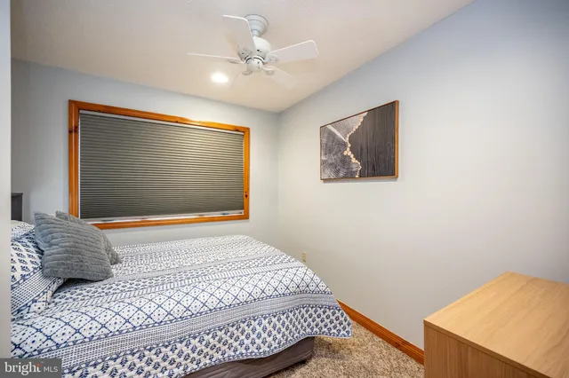 a bedroom with a bed and a painting on the wall