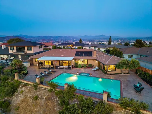 an aerial view of a house with a swimming pool yard and outdoor seating