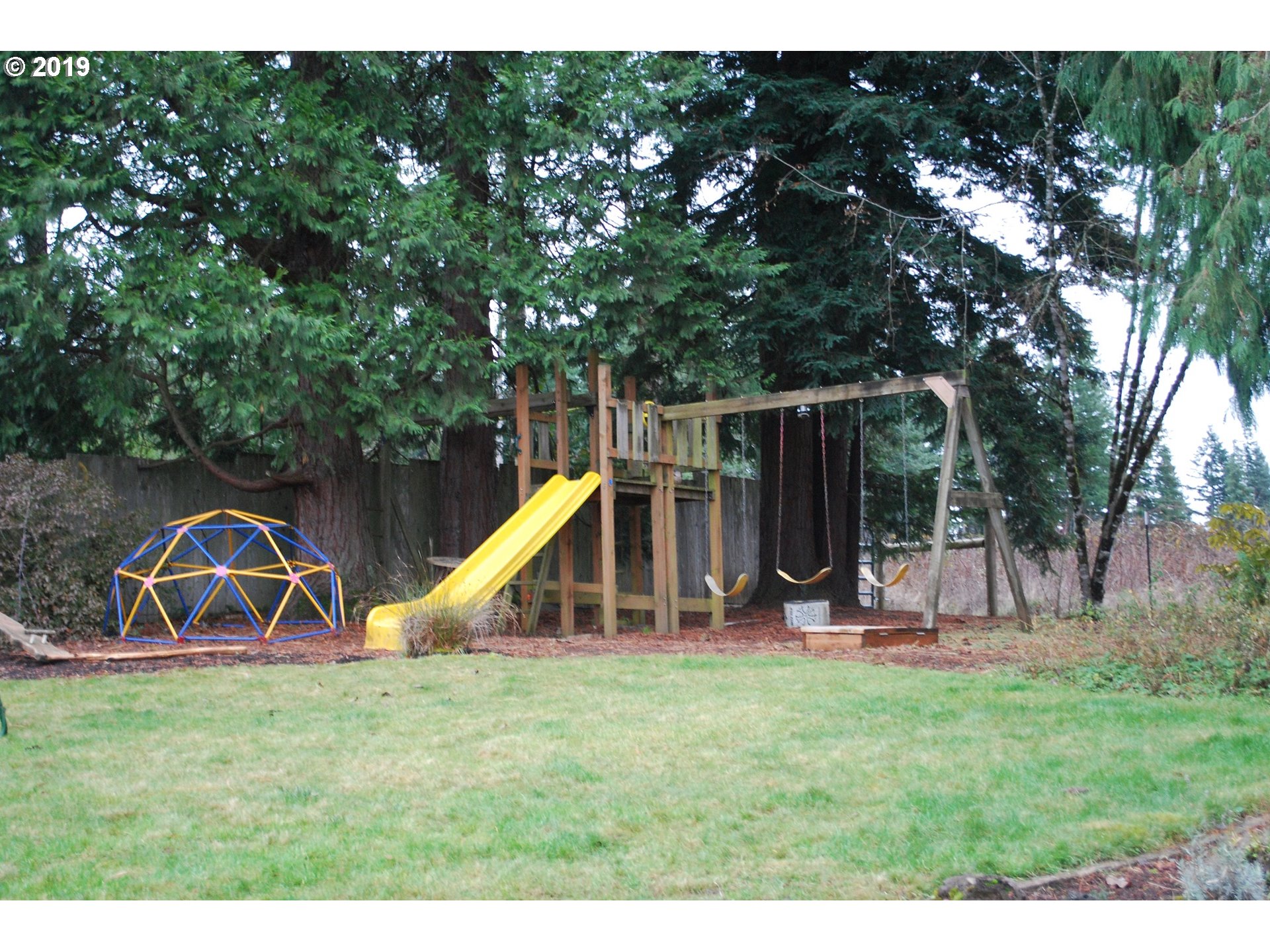 39586 Southeast Trubel Road Sandy, OR 97055 - Photo 20 of 28 a view of a backyard with a slide and a table