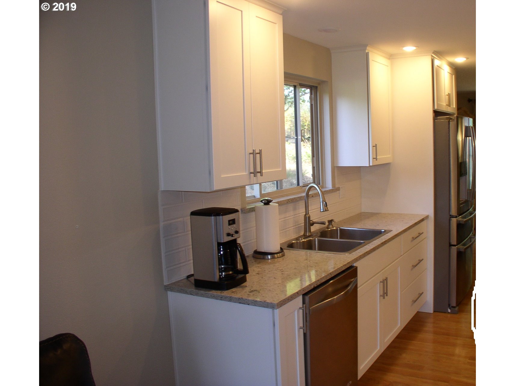 39586 Southeast Trubel Road Sandy, OR 97055 - Photo 6 of 28 a kitchen with a sink and a refrigerator