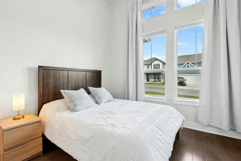 a bedroom with a bed and a window