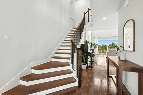 a view of entryway and hall with wooden floor