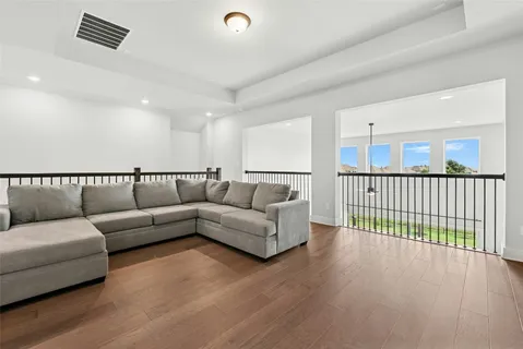 a living room with a couch and a wooden floor