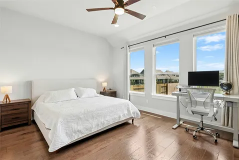 a bedroom with a bed and a desk