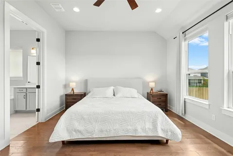 a bedroom with a bed and a large window