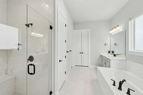 a spacious bathroom with a tub shower and mirror