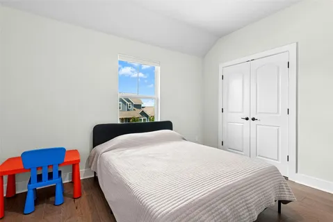 a bedroom with a bed and a table in it