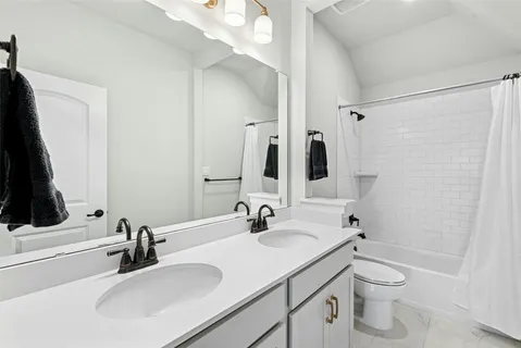 a bathroom with a double vanity sink and a mirror