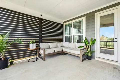 a balcony with furniture and a window