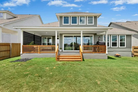 a view of a house with a yard and a large window