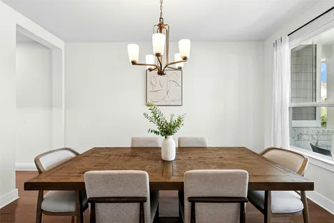 a view of a dining room with furniture and a window