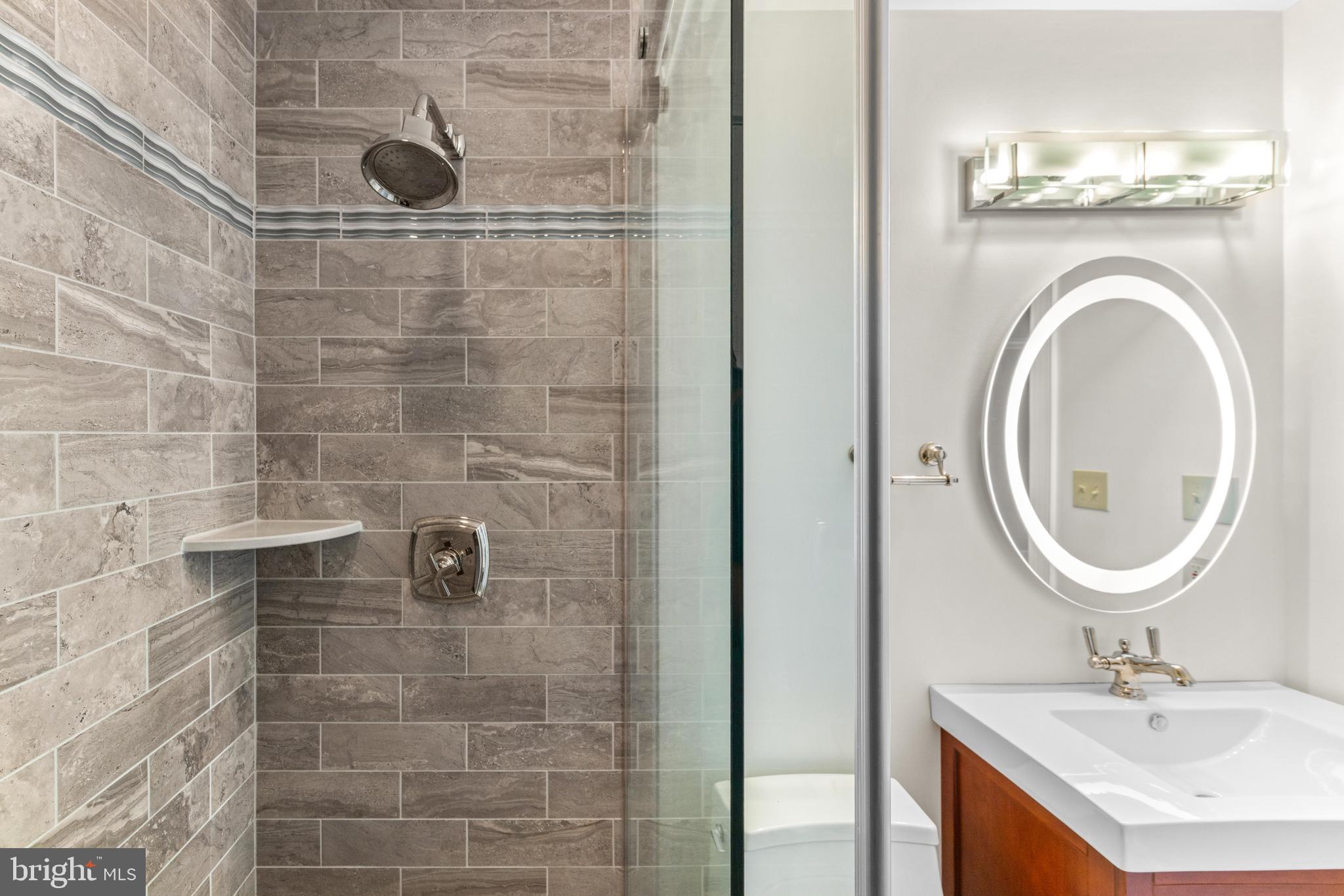 4120 Piney Grove Road Glyndon, MD 21136 - Photo 19 of 42 a bathroom with a sink a toilet and a mirror