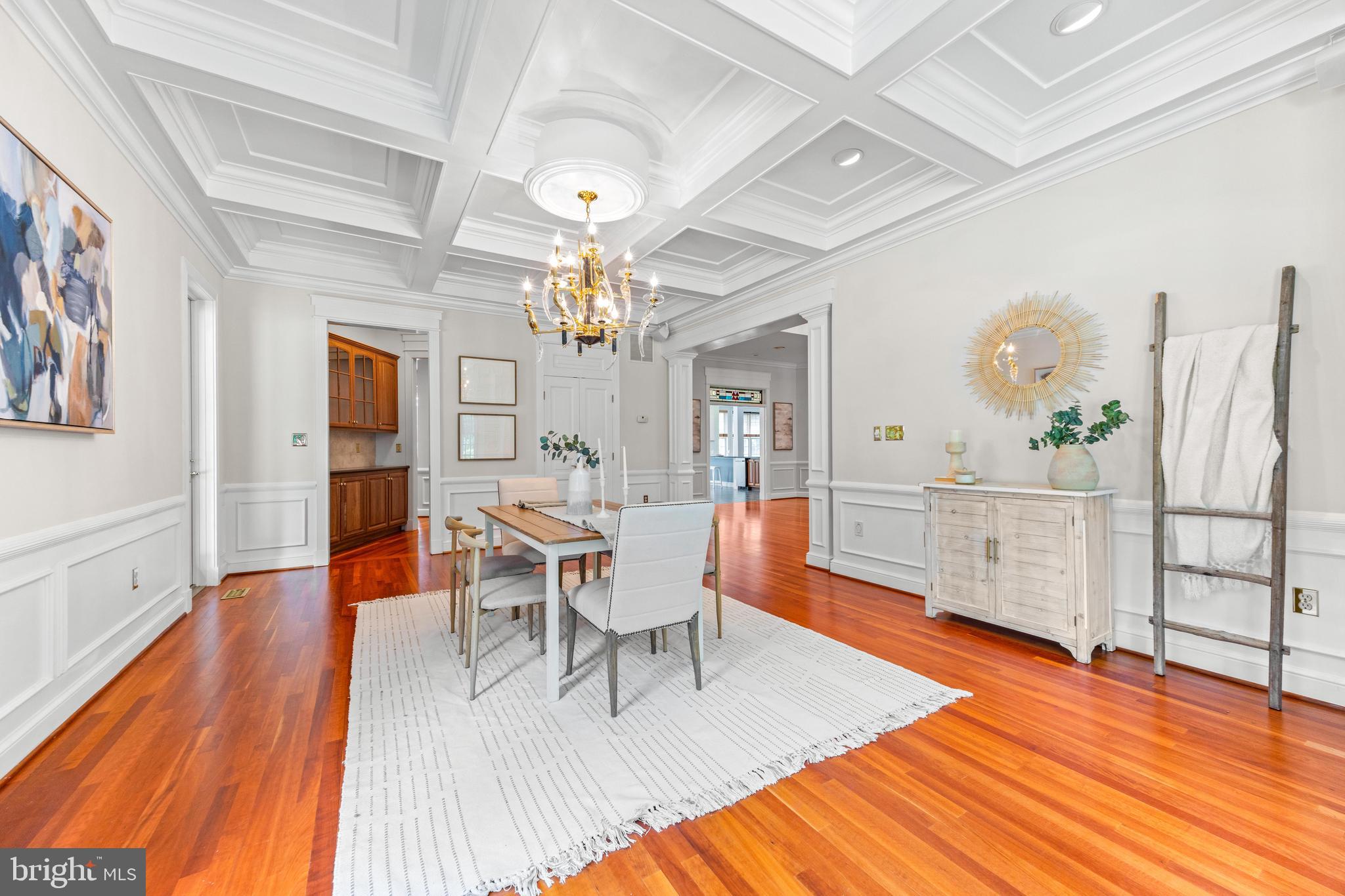 4120 Piney Grove Road Glyndon, MD 21136 - Photo 8 of 42 a dining room with wooden floor a chandelier a wooden table and chairs