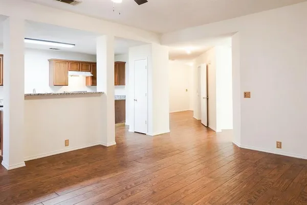 a view of a kitchen with wooden floor and a sink
