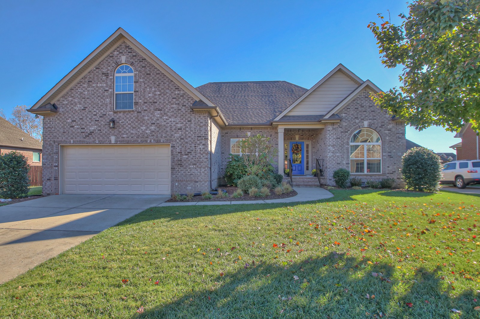 a front view of a house with a yard and garage