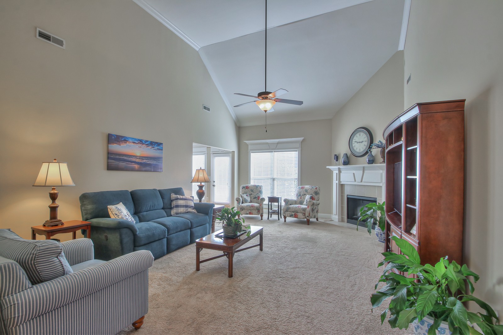 3028 Sakari Circle Spring Hill, TN 37174 - Photo 11 of 46 a living room with furniture a fireplace and a chandelier