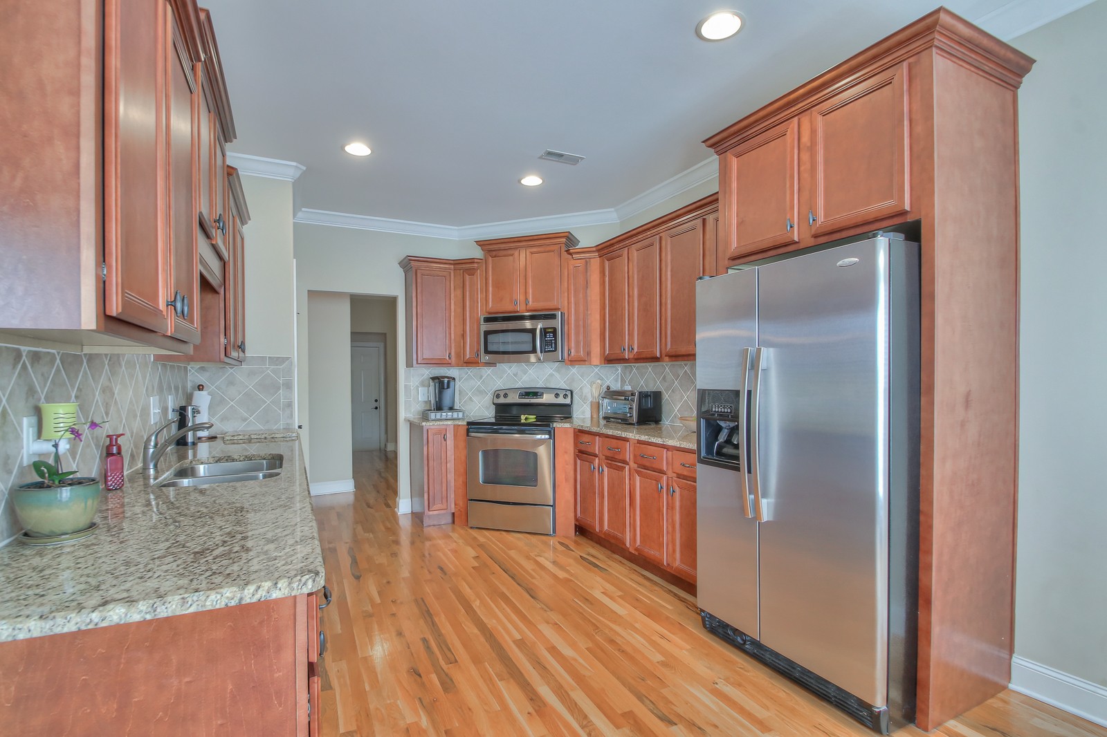 3028 Sakari Circle Spring Hill, TN 37174 - Photo 15 of 46 a kitchen with stainless steel appliances granite countertop a refrigerator sink and cabinets