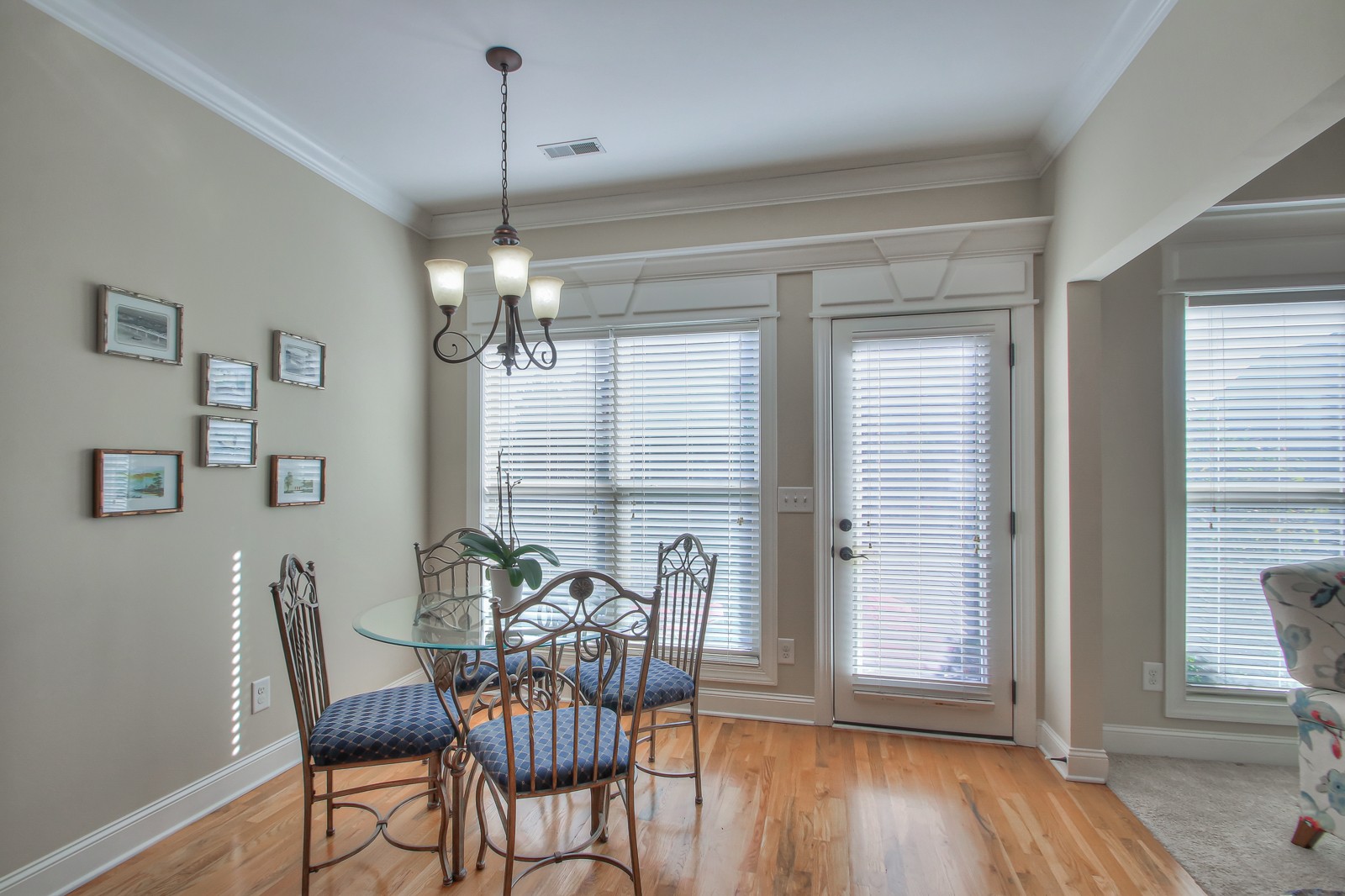3028 Sakari Circle Spring Hill, TN 37174 - Photo 19 of 46 a dining room with wooden floor a chandelier a glass table and chairs