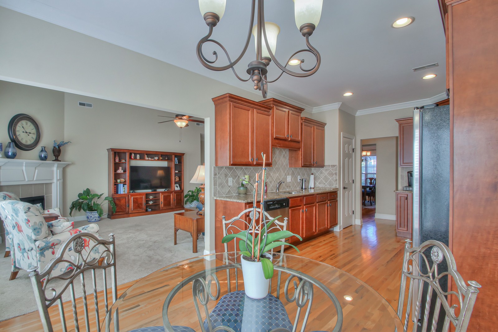 3028 Sakari Circle Spring Hill, TN 37174 - Photo 21 of 46 a view of a dining room with furniture a chandelier and wooden floor