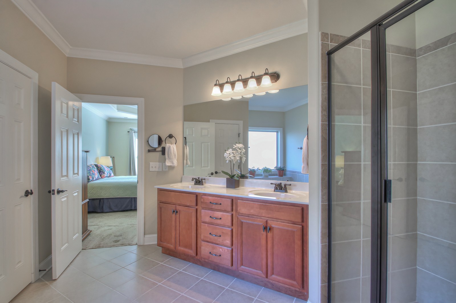 3028 Sakari Circle Spring Hill, TN 37174 - Photo 26 of 46 a spacious bathroom with a granite countertop sink a mirror a shower and a bathtub