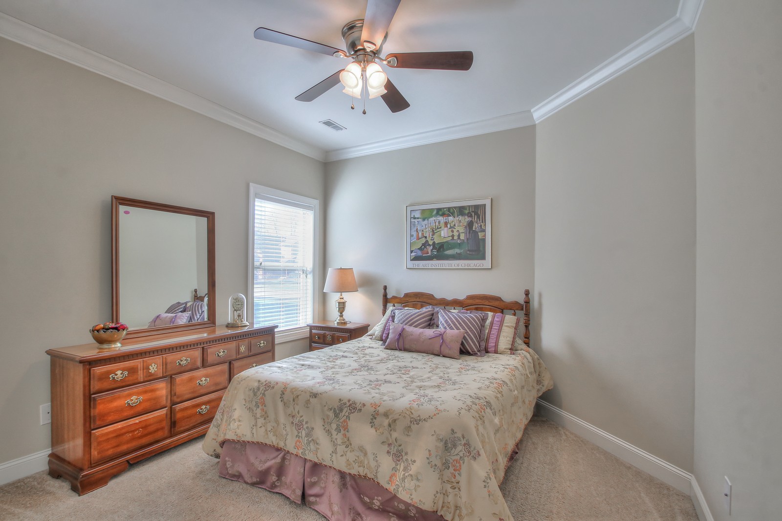 3028 Sakari Circle Spring Hill, TN 37174 - Photo 29 of 46 a bedroom with a large bed and a chandelier