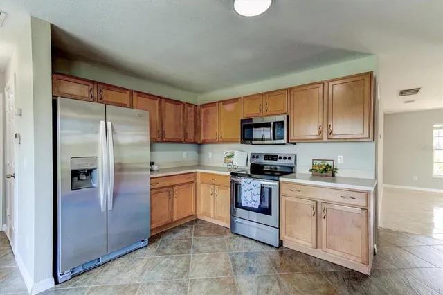 a view of kitchen and kitchen with microwave