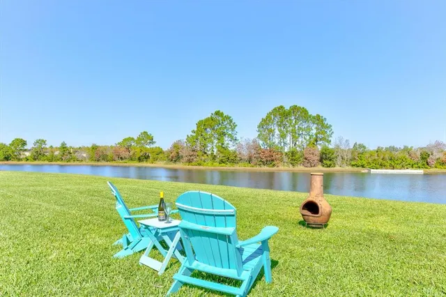 an aerial view of a house with a garden and lake view