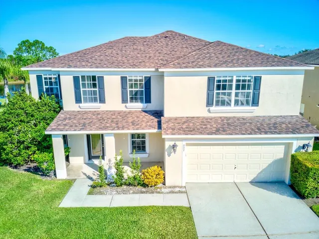 a front view of a house with a garden and yard