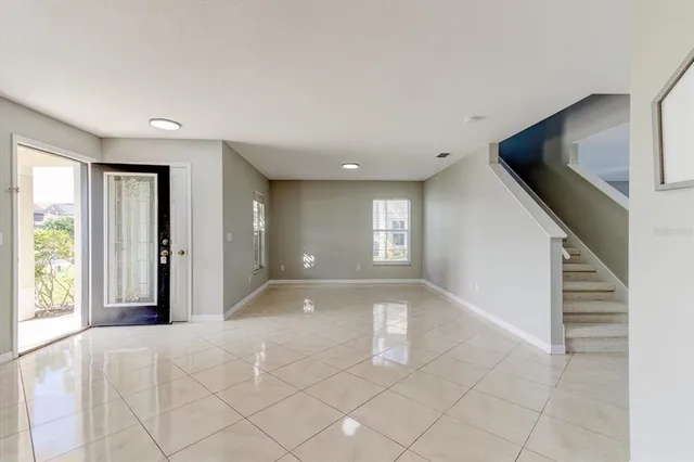 a view of a big room with closet and windows