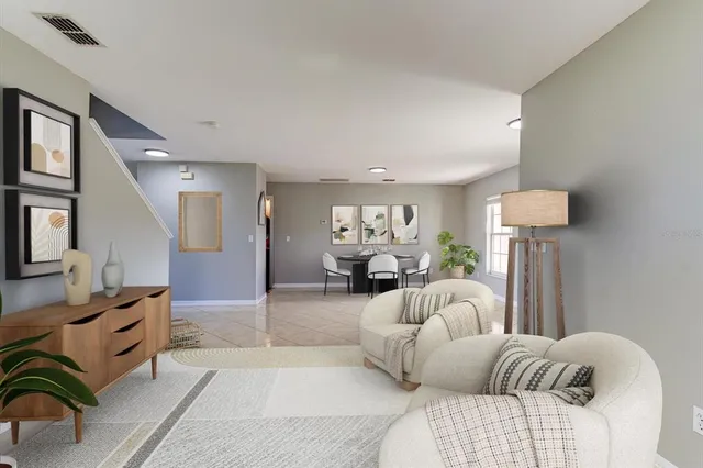 an empty room with chandelier fan and windows