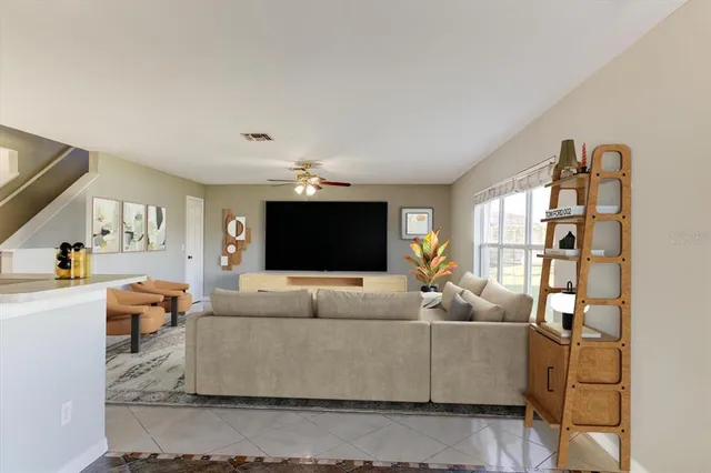 a view of a livingroom with furniture and a ceiling fan