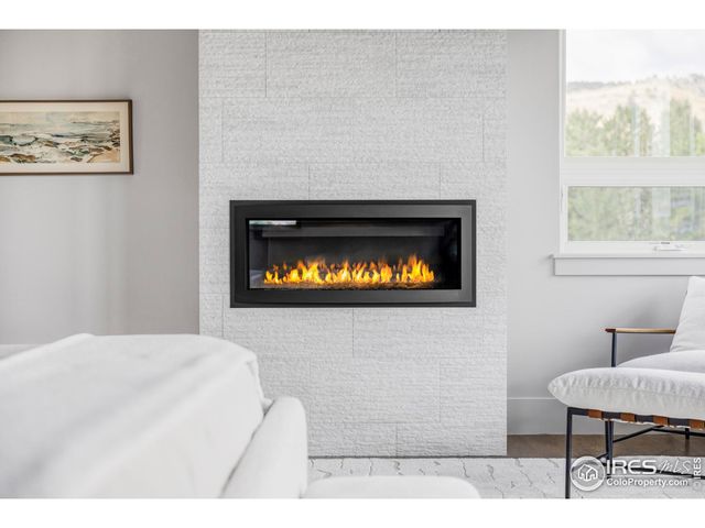 a living room with a large window and a rug