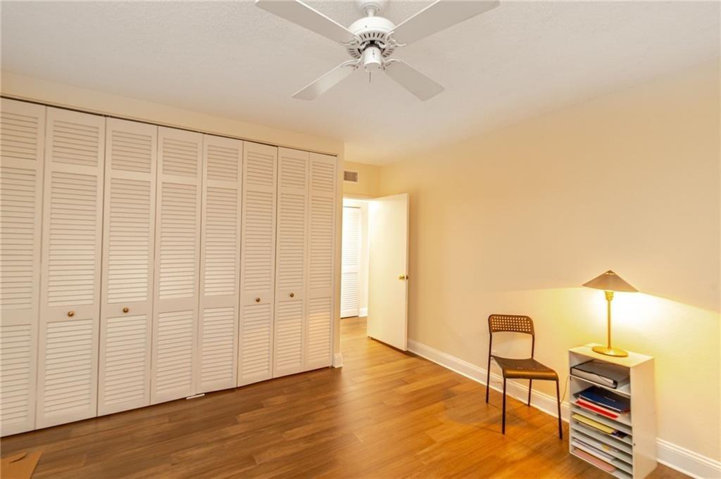 2500 East Las Olas Boulevard, Unit 308 Fort Lauderdale, FL 33301 - Photo 13 of 26 an empty room with wooden floor fan and windows