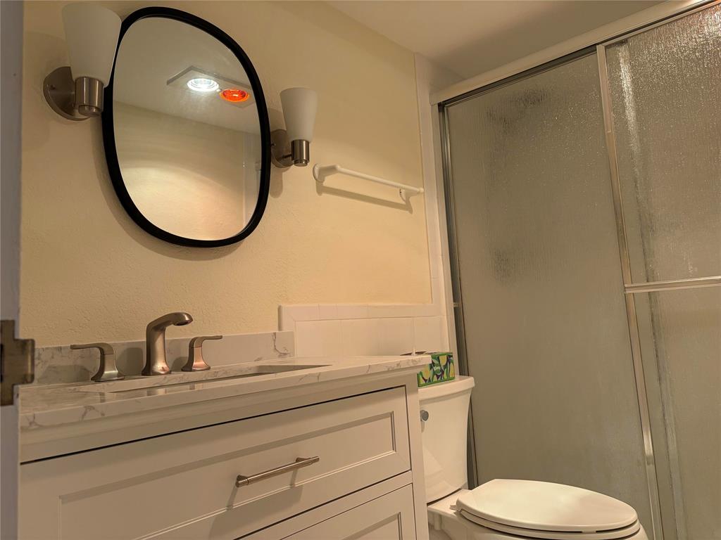 2500 East Las Olas Boulevard, Unit 308 Fort Lauderdale, FL 33301 - Photo 15 of 26 a bathroom with a toilet a sink and a mirror