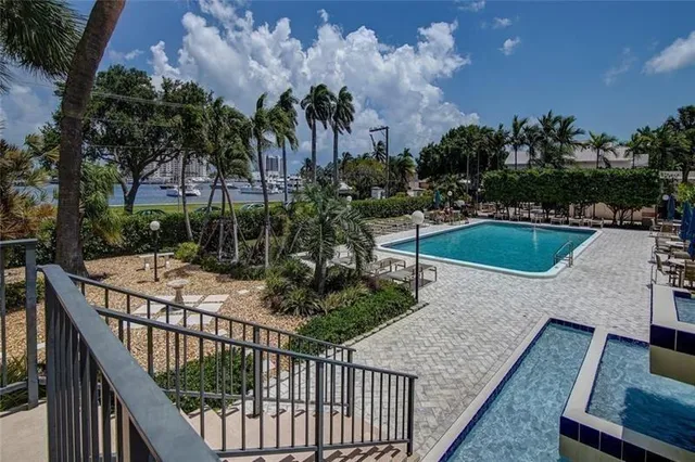 a view of a balcony with swimming pool and outdoor seating