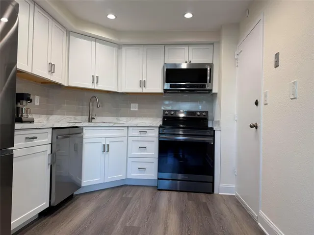 a kitchen with a sink stove and cabinets