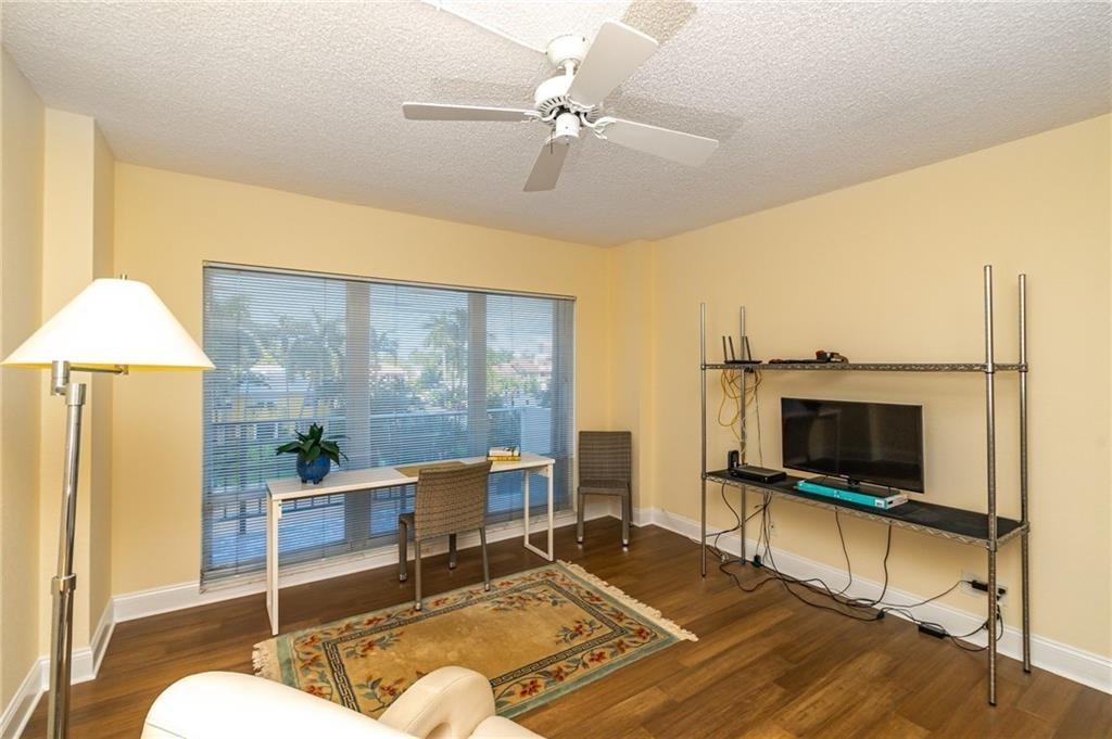 2500 East Las Olas Boulevard, Unit 308 Fort Lauderdale, FL 33301 - Photo 8 of 26 a living room with a flat screen tv and a table