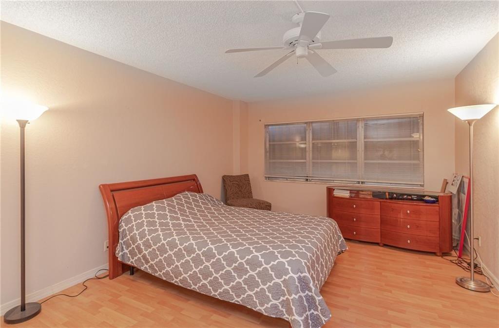 2500 East Las Olas Boulevard, Unit 308 Fort Lauderdale, FL 33301 - Photo 10 of 26 a bedroom with a bed and dresser