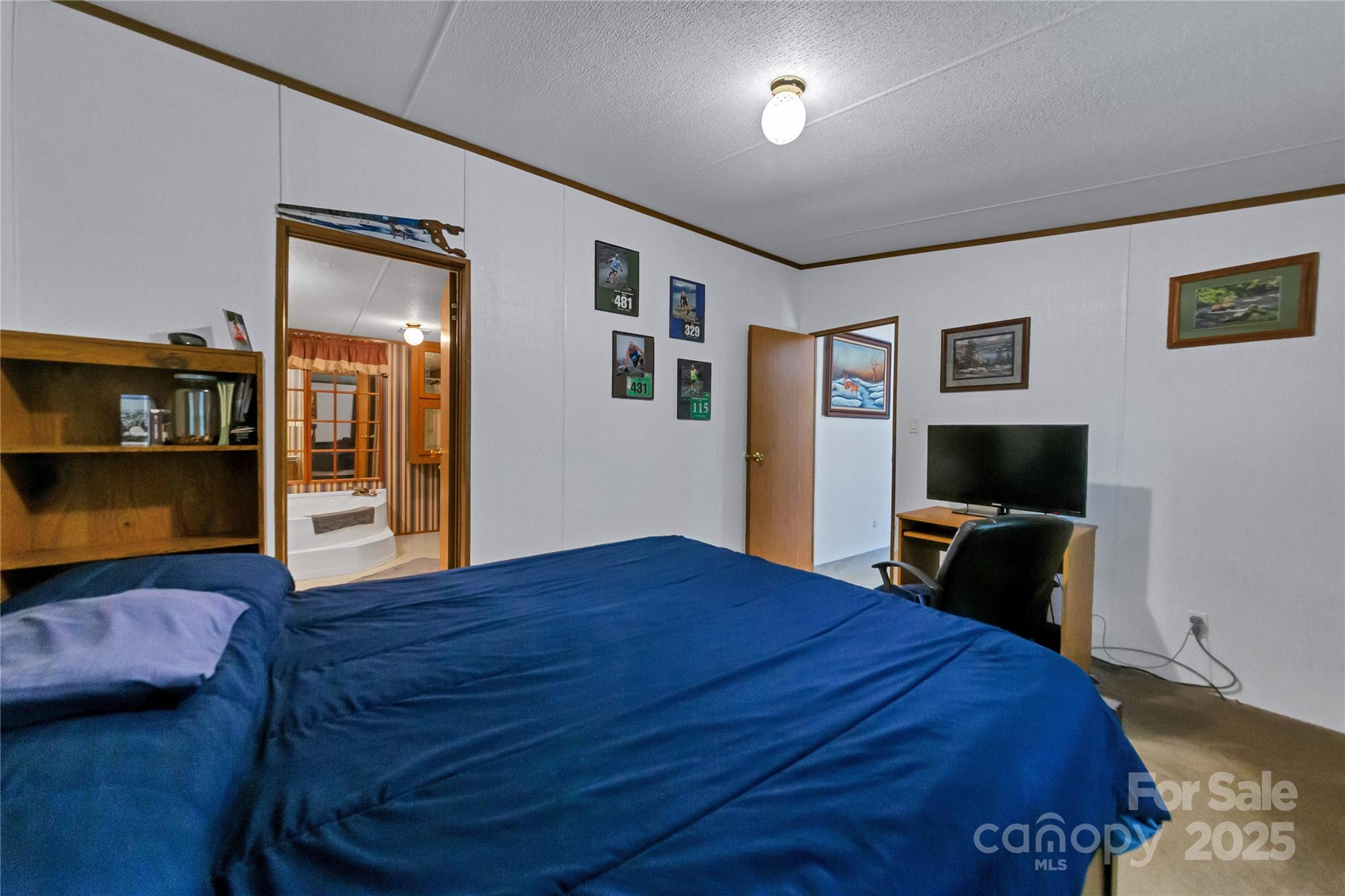 43 Goose Creek Road Swannanoa, NC 28778 - Photo 11 of 25 a bedroom with a bed and wooden floor