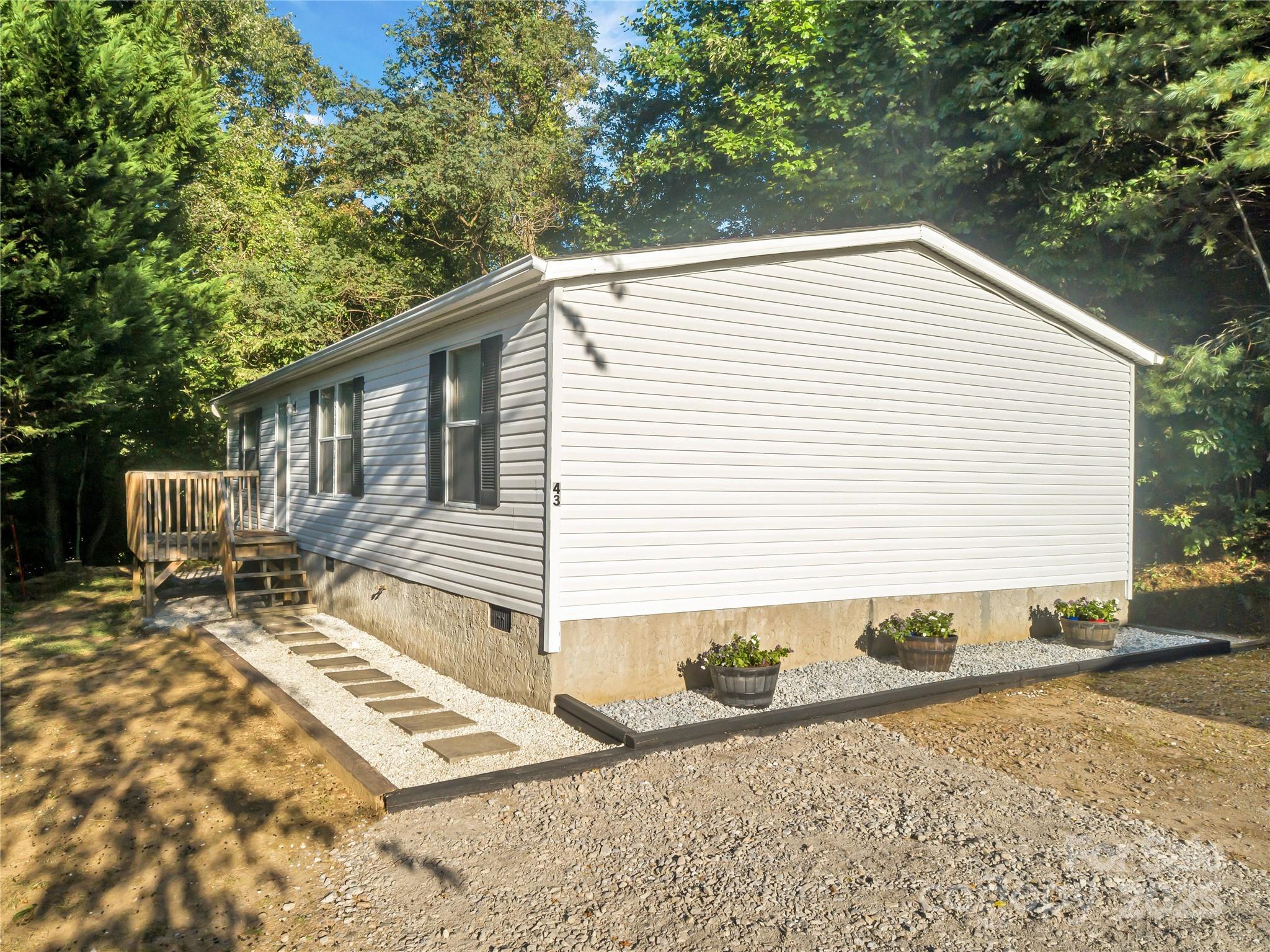 43 Goose Creek Road Swannanoa, NC 28778 - Photo 3 of 25 a backyard of a house with yard and outdoor seating