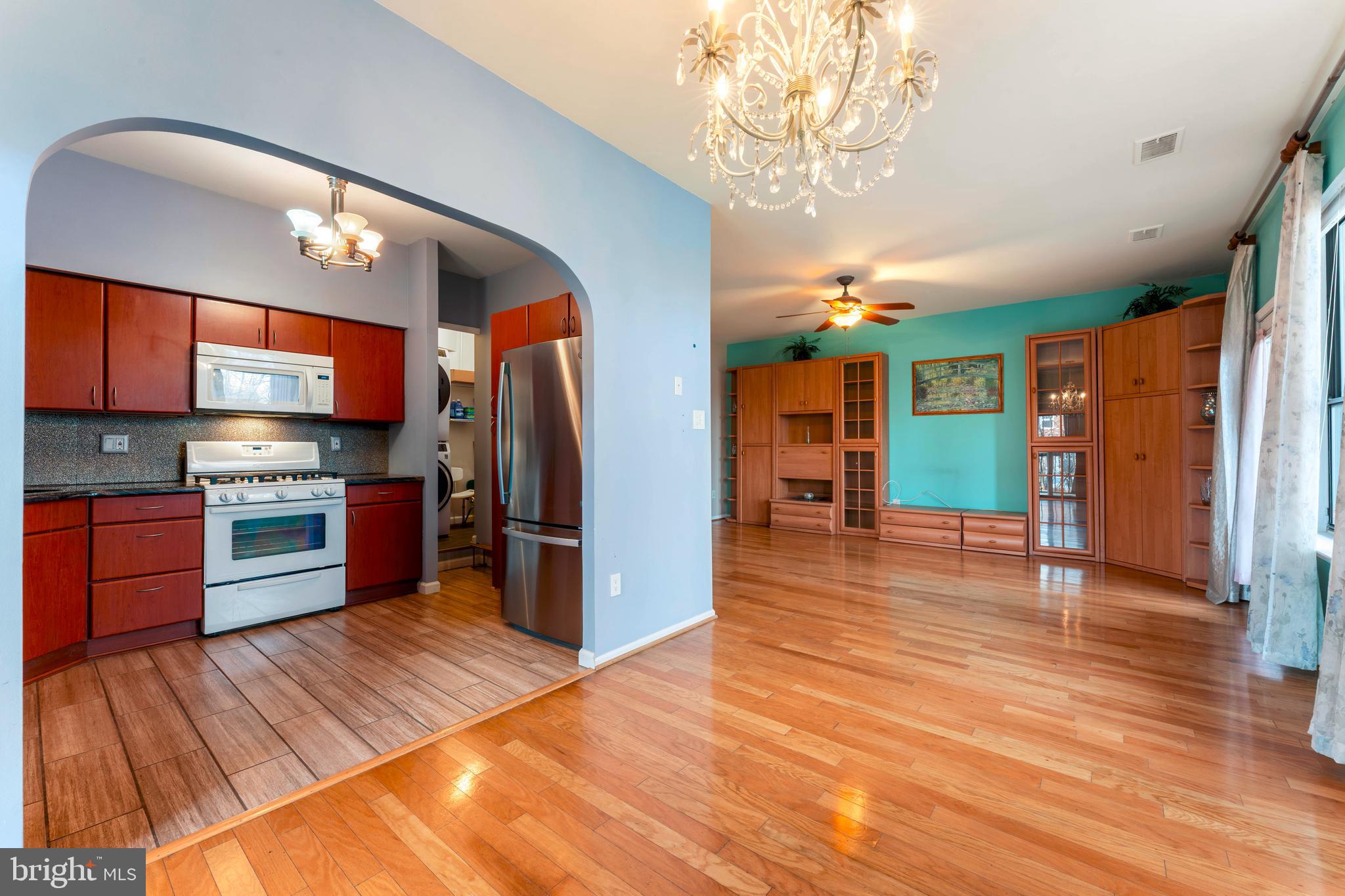 301 Byberry Road, Unit F1 Philadelphia, PA 19116 - Photo 11 of 30 a kitchen with stainless steel appliances granite countertop a refrigerator and a stove top oven