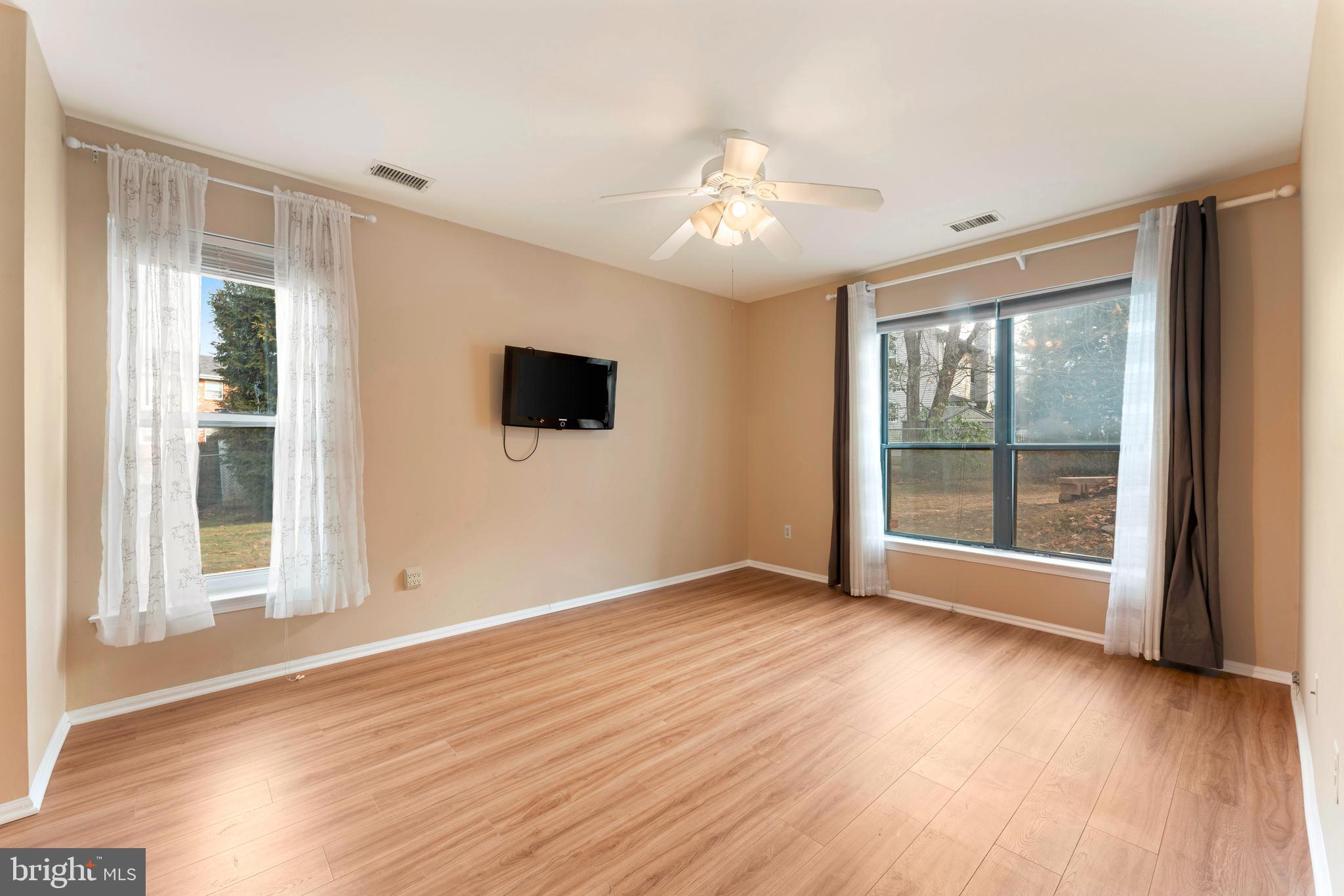 301 Byberry Road, Unit F1 Philadelphia, PA 19116 - Photo 17 of 30 a view of an empty room with wooden floor and a window