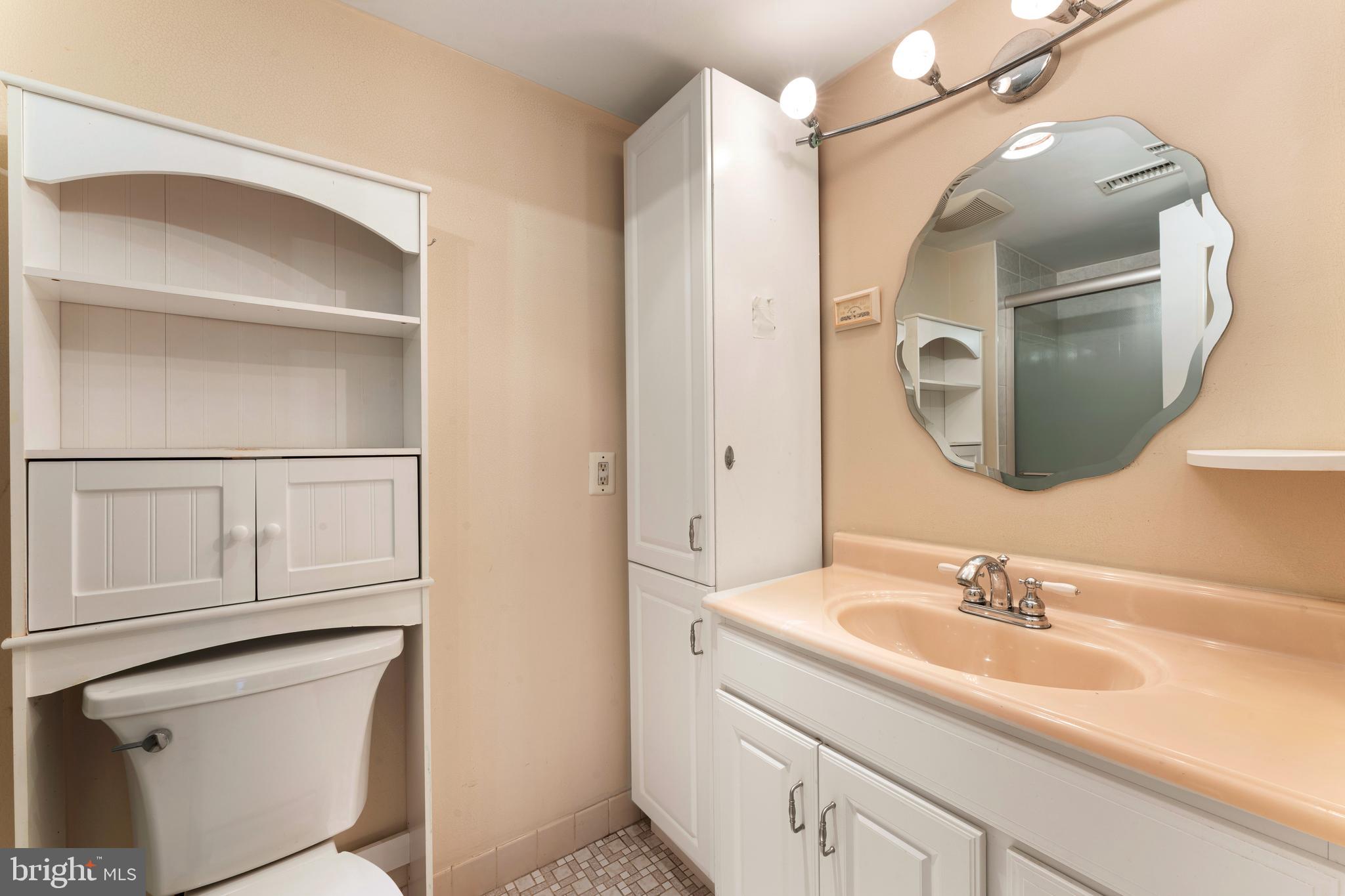 301 Byberry Road, Unit F1 Philadelphia, PA 19116 - Photo 19 of 30 a bathroom with a sink vanity granite and a mirror
