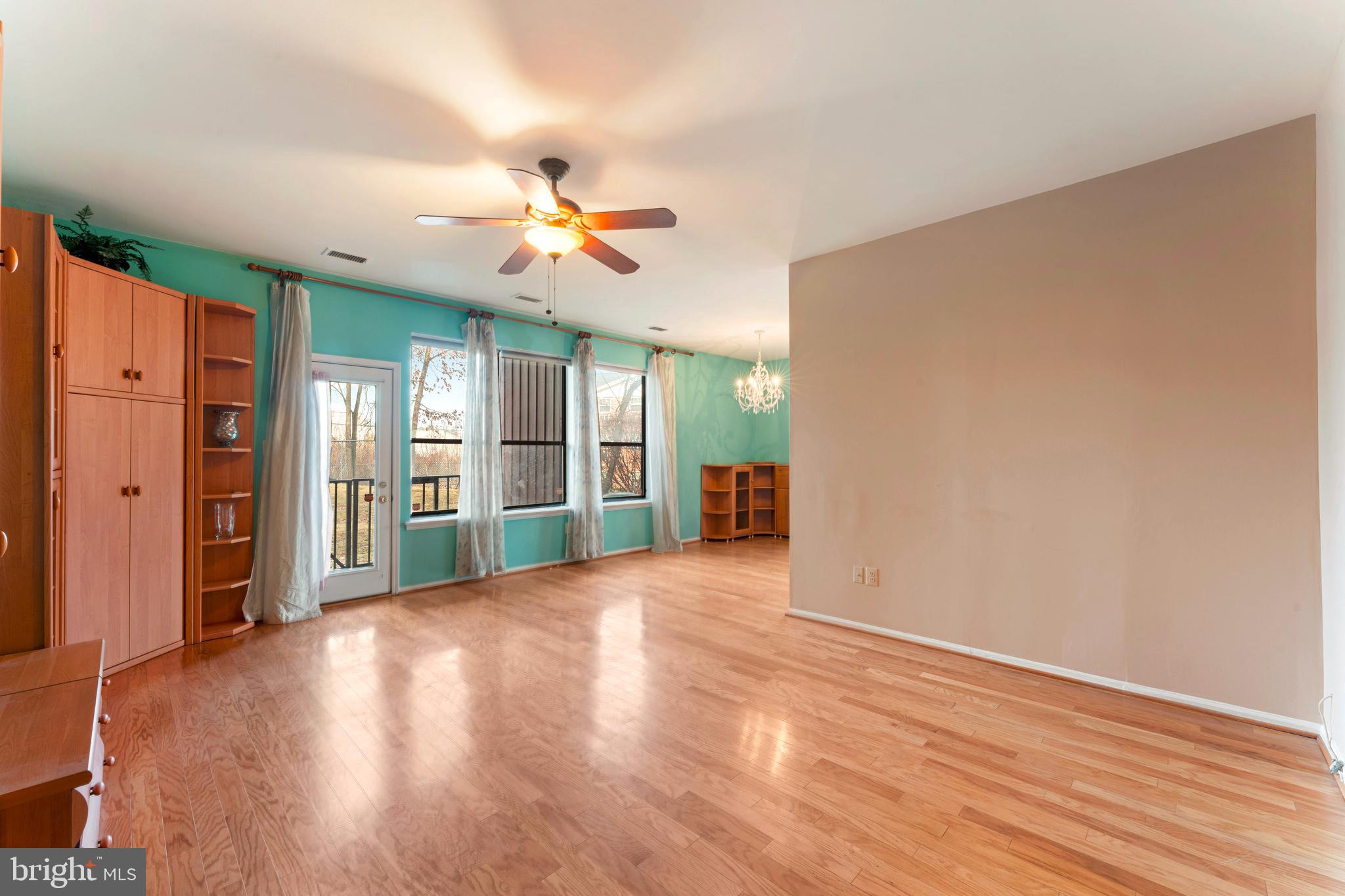 301 Byberry Road, Unit F1 Philadelphia, PA 19116 - Photo 6 of 30 a view of a livingroom with wooden floor and a ceiling fan