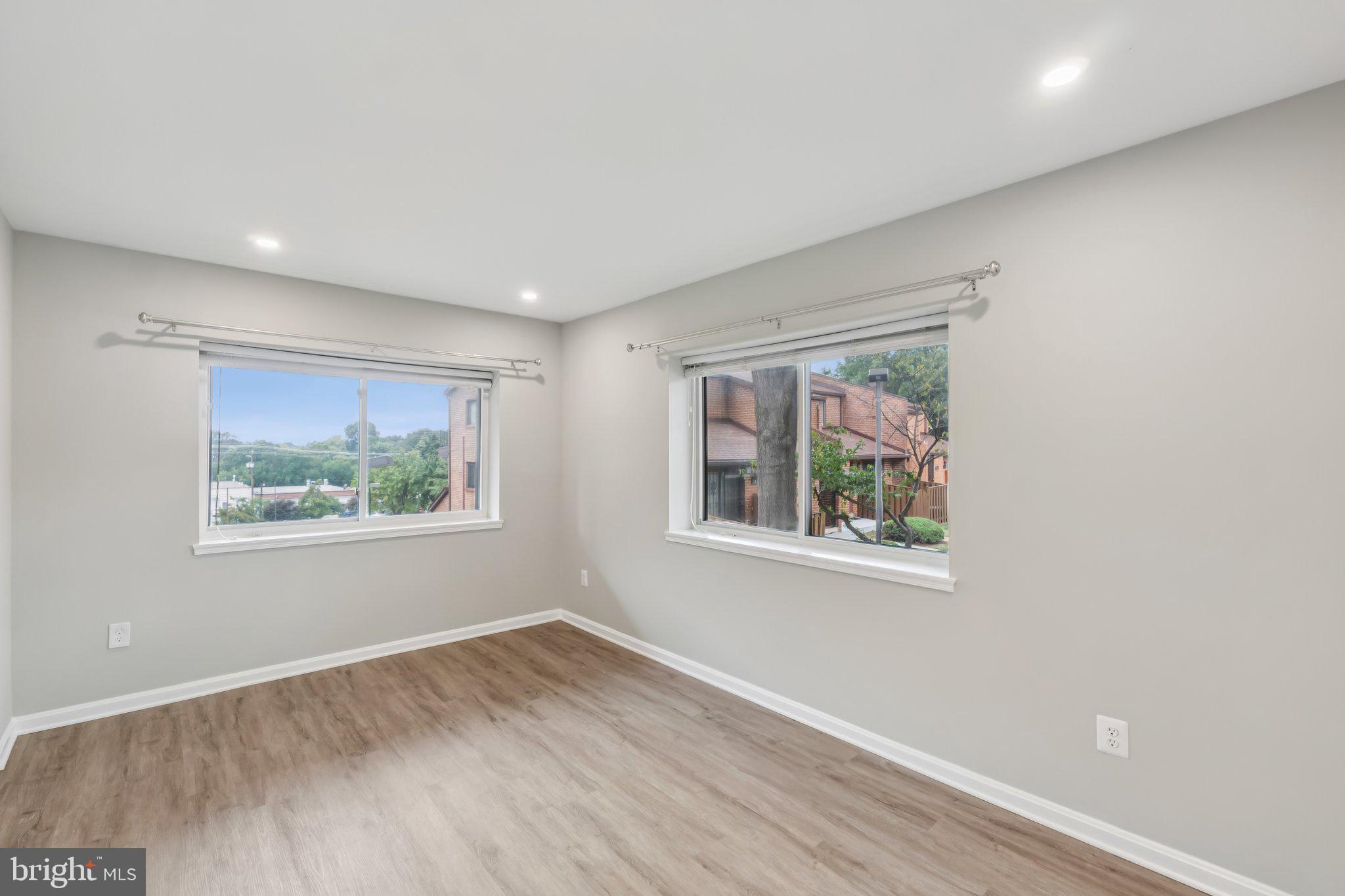 3437 Summit Court Northeast, Unit 3437 Washington, DC 20018 - Photo 12 of 26 a view of an empty room with wooden floor and a window